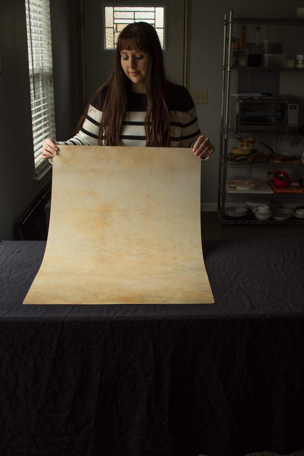 Transform your photography with the timeless elegance of the Golden Yellow Marble Replicated Photography Backdrop from Bessie Bakes Backdrops. This stunning backdrop replicates the luxurious look of real marble, featuring rich golden tones with intricate marbling for an upscale and sophisticated aesthetic.

Measuring 2 feet wide by 3 feet long and 3 mm thick, this backdrop offers a versatile canvas for food styling, product photography, flat-lays, and lifestyle imagery. The backdrop is available in two options:

 - Lightweight Physical: Semi-rigid, durable, and easy to set up for flat-lay or standing configurations. This material is great for photographers who need something sturdy and reliable.

 - Super-Thin & Pliable: Flexible, ultra-thin material that can be rolled up and stored with ease. Perfect for travel photographers or those needing a space-saving solution without sacrificing visual quality.

Both options are moisture-resistant and designed to withstand the demands of professional photography, ensuring the backdrop remains pristine shot after shot. Whether you're capturing gourmet dishes or high-end products, the golden yellow marble texture adds depth and richness to any composition.