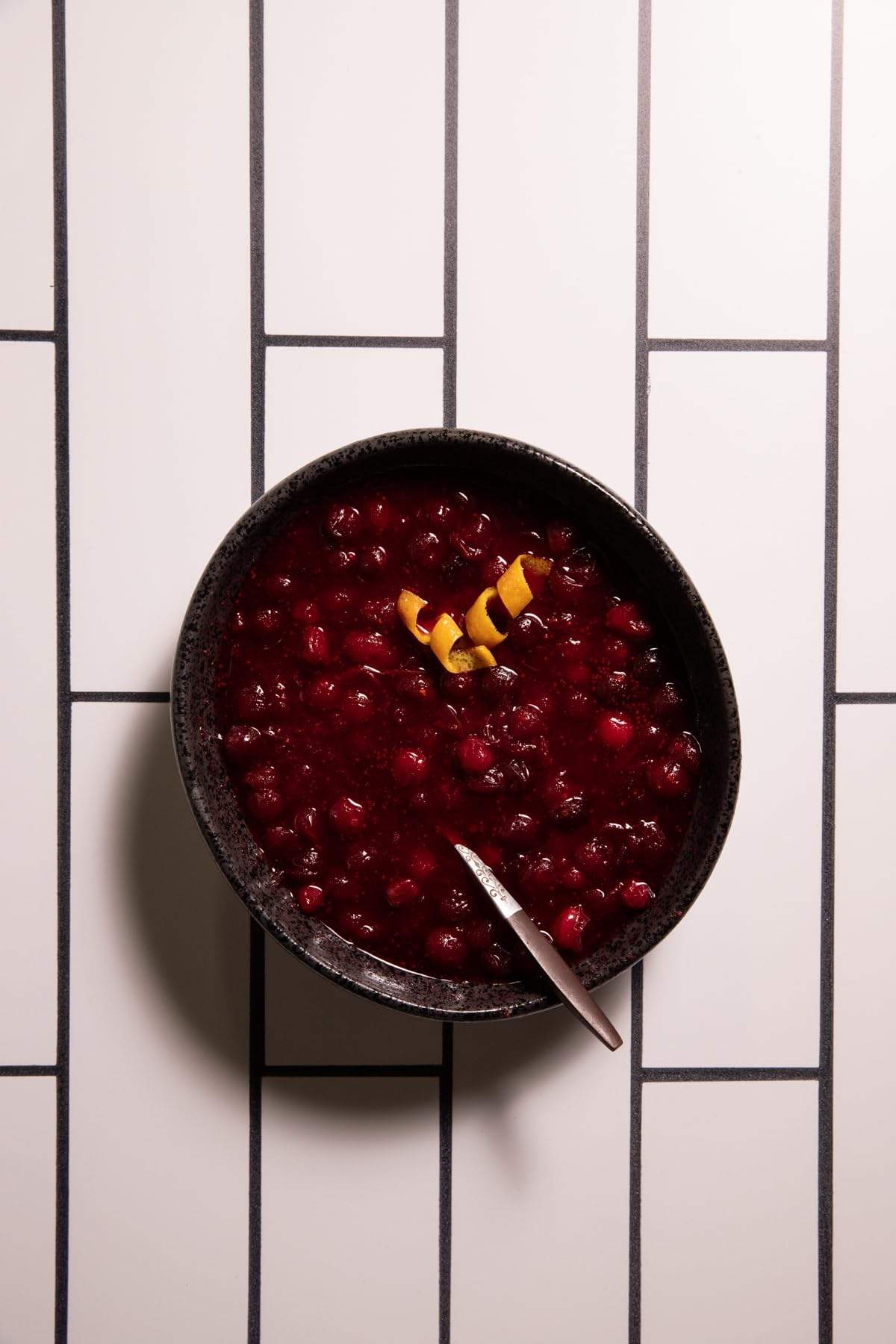 Add a sleek, modern look to your photography with the White Subway Tile with Black Grout Backdrop from Bessie Bakes Backdrops. This photography backdrop captures the clean, minimal aesthetic of classic subway tiles, enhanced with a bold contrast of black grout. Ideal for food styling, product photography, or lifestyle imagery, the smooth surface and simple design offer a crisp background that ensures your subject stands out beautifully.

The backdrop measures 2 ft x 3 ft and comes in a Lightweight Physical material that’s semi-rigid and ⅛-inch thick, making it durable and easy to use in flat-lay or standing setups. Whether you're creating content for social media or building a professional portfolio, this versatile backdrop will elevate your compositions with a refined, contemporary edge.