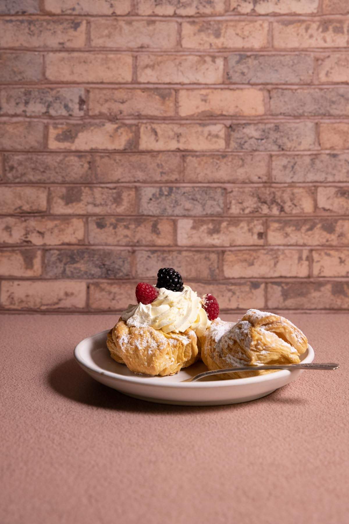 Introducing the Brown & Denim Brick Photography Backdrop by Bessie Bakes—a versatile and rustic-inspired backdrop that merges warm brown hues with subtle denim undertones for a textured, lived-in aesthetic. Perfect for capturing the charm of artisan food, product displays, and lifestyle compositions, this backdrop adds depth and character to your photography, making your subjects stand out in every frame.

This backdrop is available in both the Lightweight Physical and Super-Thin & Pliable options. The 2 ft x 3 ft Lightweight Physical material is semi-rigid and ⅛-inch thick, offering a sturdy and flat surface ideal for overhead shots. The Super-Thin & Pliable material can be easily clipped to a rigid board for upright shooting or used seamlessly for flexible setups, remaining durable and easy to handle.